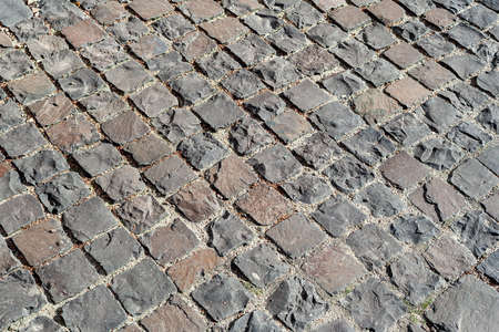 Cobblestones background. Paved road. Cobblestone surface. Selective focus.の写真素材