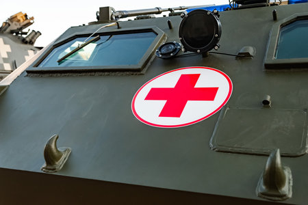 The sign of the red cross on the medical armored personnel carrier of the Ukrainian army. Exhibition of military equipment in Kiev. Modern military technology. Ukraine. Kiev. October 15, 2021のeditorial素材