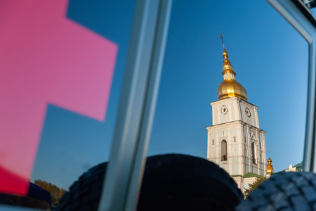 Red cross and reflection in the window of a military medical vehicle of the Ukrainian army. Exhibition of military equipment in Kiev. Modern military technology. Ukraine. Kiev. October 15, 2021のeditorial素材