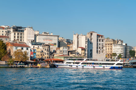 Tourist ship at the pier in the Galata Tower area in the Golden Horn Bay in Istanbul. Istanbul. Turkey - 09.25.2021.のeditorial素材