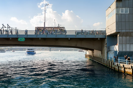 Transport on the Galata Bridge near the Galata Tower in the Golden Horn Bay in Istanbul. Istanbul. Turkey - 09.25.2021.のeditorial素材