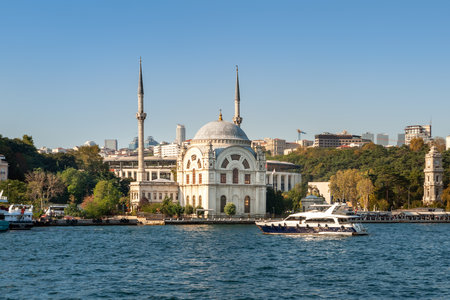 Dolmabahce Mosque. A boat at the Ortakoy Mosque in the Bosphorus Strait in Istanbul. Istanbul. Turkey - 09.25.2021.のeditorial素材
