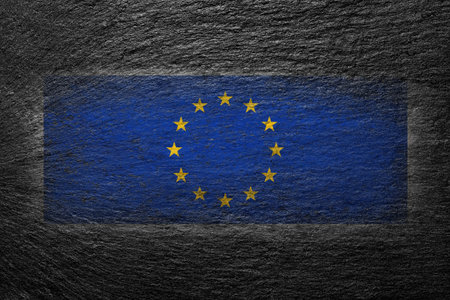 EU flag. European Union flag is painted on a black stone. creative background.