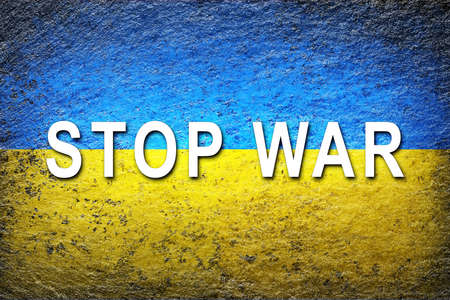 Ukraine flag. Ukrainian flag with the white slogan STOP WAR is painted on a rough surface. creative background.の写真素材