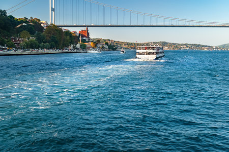 Ship in the Bosphorus. Tourist ship under the bridge in the Bosphorus in Istanbul. Tourist locations. Istanbul. Turkey. 09/25/2021.のeditorial素材