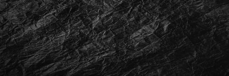 Crumpled black kraft paper. Texture of crumpled black recycled paper. Wallpaper for web design.