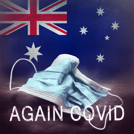 Inscription Again Covid and a crumpled medical mask on the flag of Australia. Return of the coronavirus. New jump in incidence. Omicron and Dedta strain. Danger of a viral infection. medical conceptの写真素材