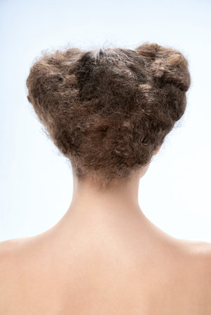 Back view of young woman. Nude young caucasian brunette woman. dark hair. Stylish hairstyle. isolated on a light backgroundの写真素材