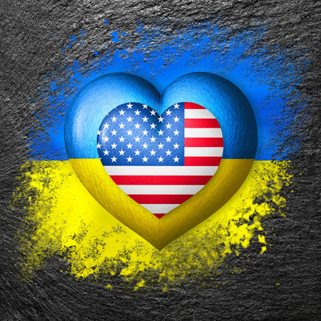 Flags of Ukraine and USA. Two hearts in the colors of the flags are painted on the stone. Concept of protection, solidarity, cooperation and assistance of countriesの写真素材
