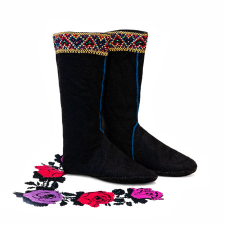 Ukrainian national wool shoes. Hutsul Capchuri on a white background with a pattern. Traditional folk shoesの写真素材