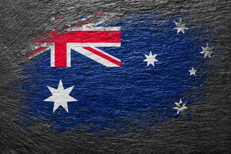 Flag of New Zealand. Flag is painted on a stone surface. stone background. Black slate background. creative backgroundの写真素材