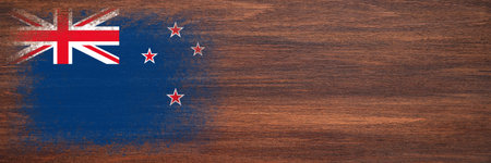Flag of New Zealand. Flag is painted on a wooden surface. wooden background. Plywood surface. copyspace. textured creative backgroundの写真素材