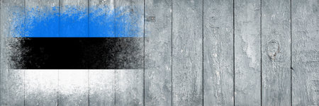 Flag of Estonia. Flag is painted on a gray wooden plank surface. wooden background. Plywood surface. copyspace. textured creative backgroundの写真素材