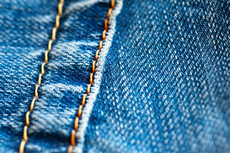 Jeans background. Denim with yellow stitching. selective soft focusの写真素材
