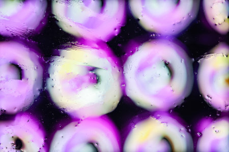 Blurred abstract background. Abstract image of tin beer cans through wet glass. water drops....
