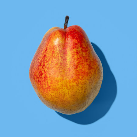 Ripe pearl. Ripe pear on a blue background close-up. one ripe fruit. sharp shadow