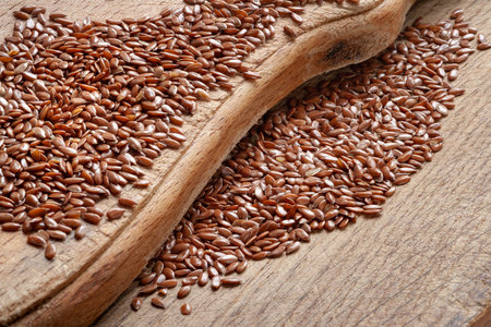 Flax seeds. Flax seeds are scattered on a wooden board close-up. Omega 3 Healthy nutrition. top viewの写真素材
