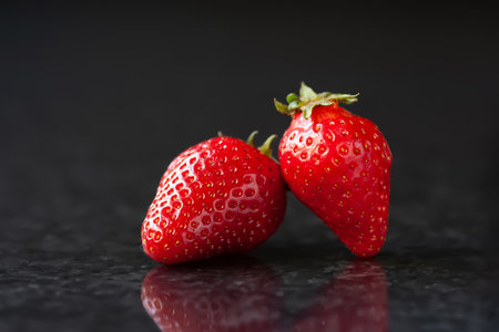 Strawberry. Red ripe strawberries on a black marble background. selective soft focusの写真素材