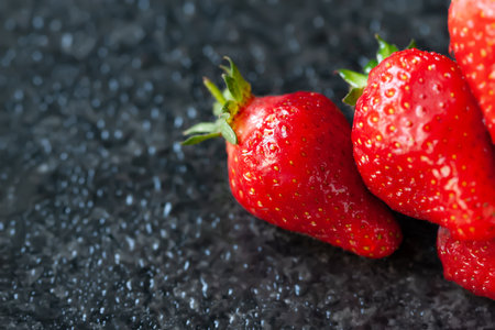 Ripe strawberries. Juicy ripe strawberries with water drops on a wet background. red berries. copyspace. close-up. selective soft focusの写真素材