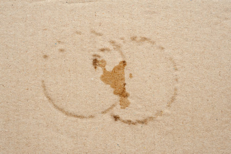 Cardboard texture with wet spots. Brown cardboard with round wet spots of water. Crumpled cardboard with surface texture. Cardboard sheet of paperの写真素材