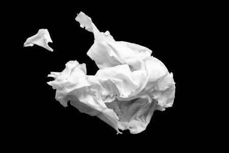 Wet crumpled paper. Crumpled sheet of wet paper on a black background. selective soft focusの写真素材