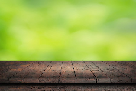 wooden surface. painted boards. Old dark table. wooden table on natural green blurred defocused backgroundの写真素材