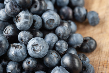 blueberries. Fresh blueberries on a wooden table close-up. Sprinkle blueberries. Scattered fresh blueberries. selective soft focusの写真素材