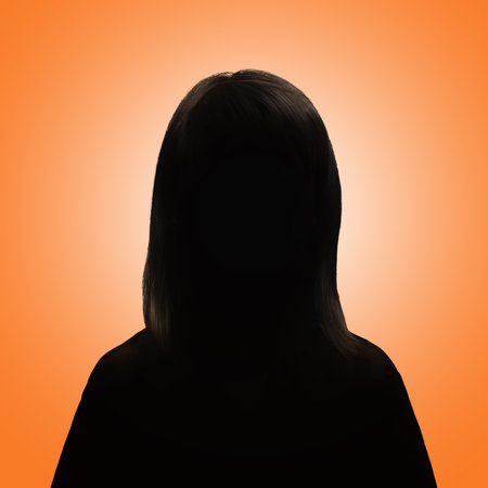 Silhouette of a girl. Girl's avatar. Girl posing on an orange backgroundの写真素材
