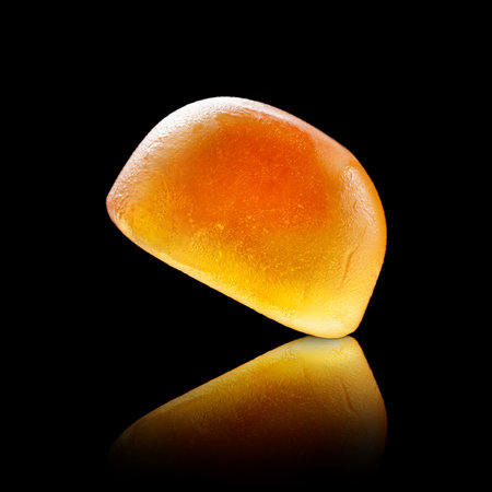 Jelly candies. Set of jelly orange candy reflected on a black background. Close-upの写真素材