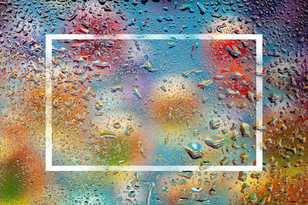 Abstract background. Drops of water on the glass. Raindrops on the window. Multi-colored spots. Texture of drops. Selective soft focusの写真素材