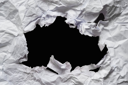 Torn damp paper. A ripped hole in crumpled paper. Abstract textureの写真素材