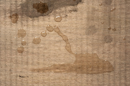 Wet cardboard. Wet spots on dirty corrugated cardboard. Abstract textureの写真素材