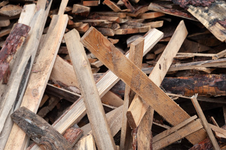 Pile of wet broken boards at the sawmill. Soft focus