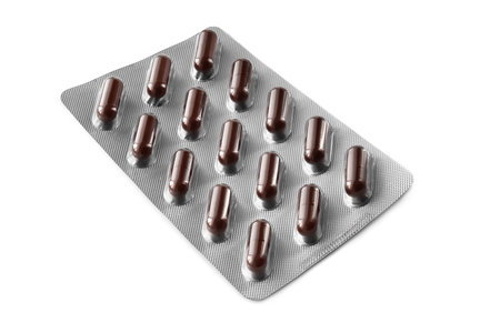 Pills in a blister. Medicine packaging isolated on white background. Medicine in pillsの写真素材