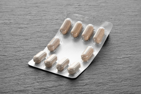 Pills in a blister. Packaging of medicines on a dark background. Medicine in pillsの写真素材