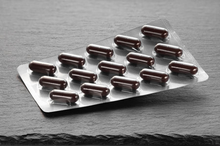 Pills in a blister. Packaging of medicines on a dark background. Medicine in tabletsの写真素材