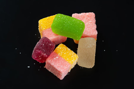Multicolored marmalade. Jelly candies on a black background. Sweets for everyoneの写真素材