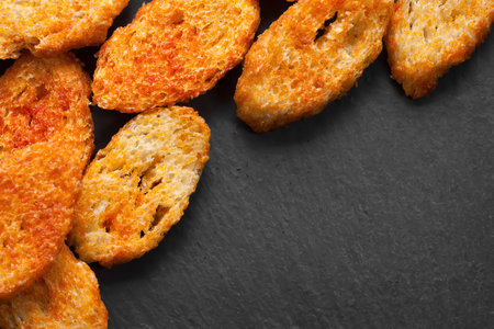 Fried croutons. Copy space. Croutons on a dark backgroundの写真素材