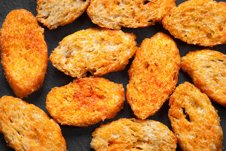 Fried croutons. Top view. Croutons on a dark backgroundの写真素材