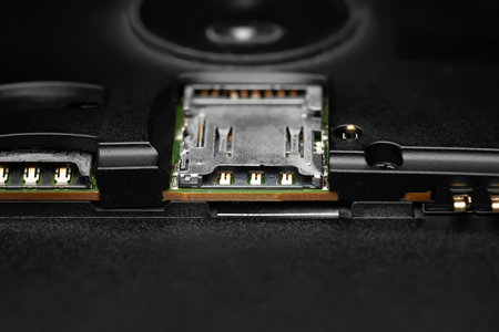 Disassembled smartphone. Macro photo of the disassembled gadget with connectors for SIM cards and battery. Soft focusの写真素材