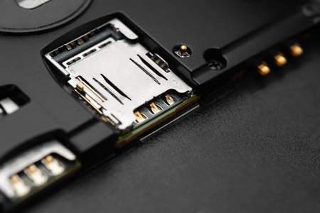 Dismantled smartphone. Close-up of a disassembled gadget with SIM card connectors. Selective soft focusingの写真素材