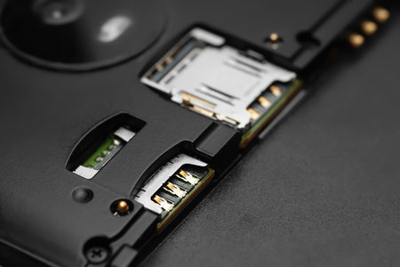 Disassembled smartphone. Close-up of the disassembled gadget with connectors for SIM cards. Soft focusの写真素材