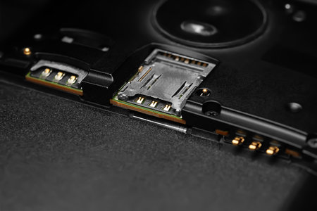 Disassembled smartphone. Close-up of the disassembled gadget with connectors for SIM cards and battery. Soft focusの写真素材