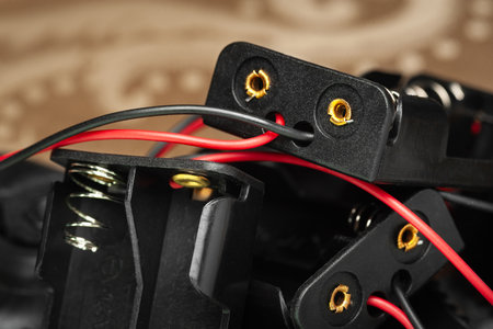 Battery holder. Close-up of plastic battery holder with cables and connectors. Selective soft focus.の写真素材