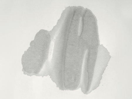 Wet spot on paper. Blank wet sheet of old paper. Texture of paper damaged by splashesの写真素材