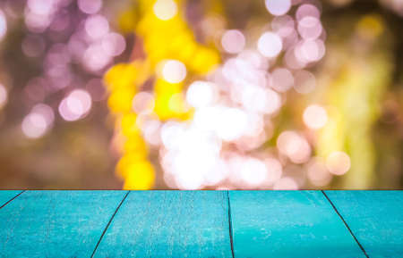 An Empty vintage wooden deck table with natural bokeh background. Product display template.の写真素材