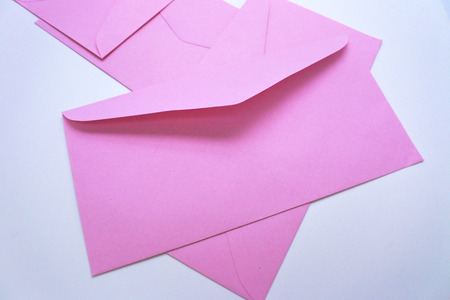pink envelope on white backgroundの写真素材