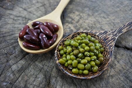 Green beans and Red bean in the wooden spoon on wood backgroundの写真素材