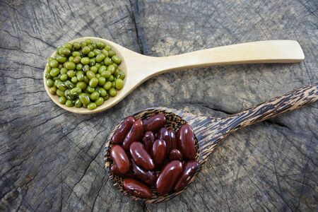 Green beans and Red bean in the wooden spoon on wood backgroundの写真素材