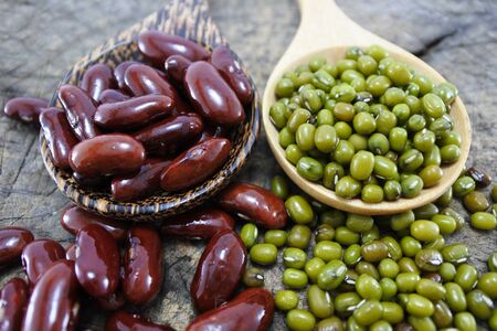 Green beans and Red bean in the wooden spoon on wood backgroundの写真素材